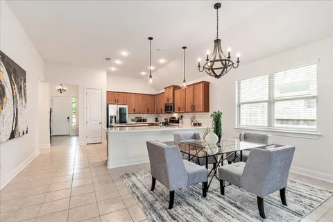 a kitchen with a table and chairs in it
