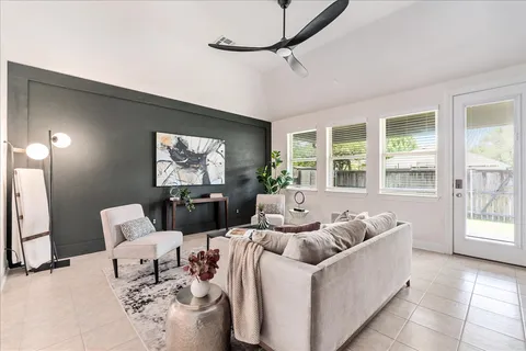 a living room with furniture stairs and a window