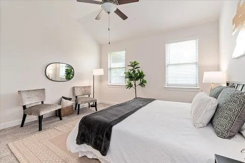 a bedroom with a bed and a chandelier