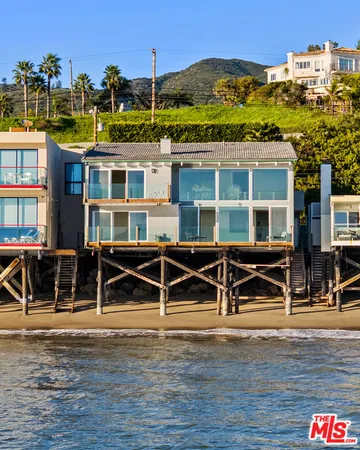 a view of a house with pool and chairs