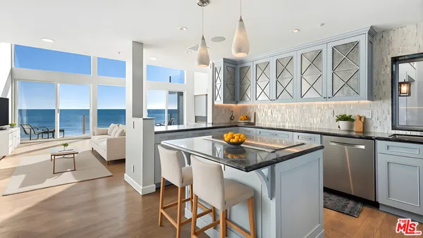 a kitchen that has a table and chairs in it