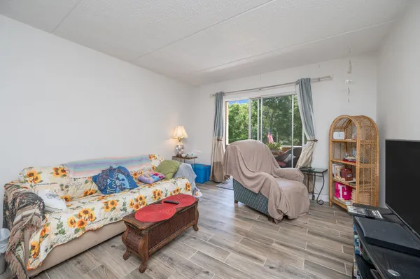 a bedroom with furniture and wooden floor