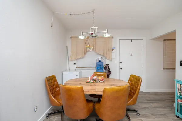a dining room with furniture and wooden floor