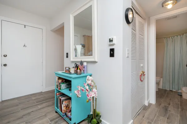 a bedroom with a bed and a view of closet