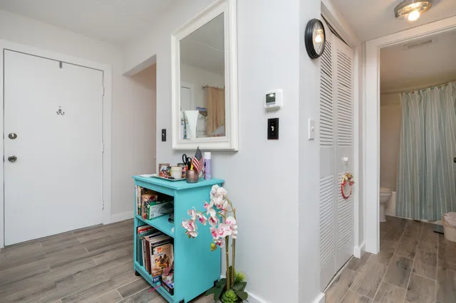 a bedroom with a bed and a view of closet