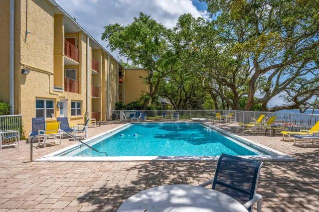 a view of swimming pool with a lounge chairs