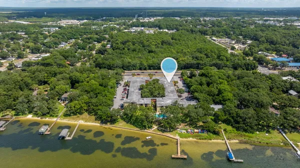 a large white kitchen with stainless steel appliances and cabinets