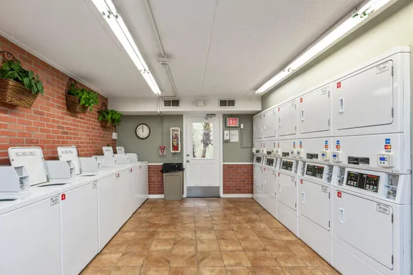 a living room with furniture a window and a chandelier