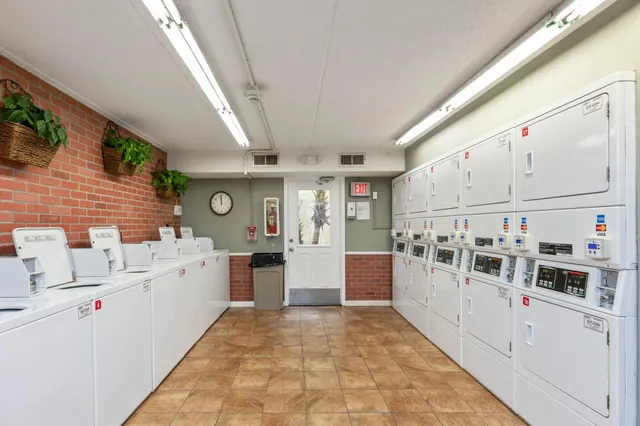 a living room with furniture a window and a chandelier