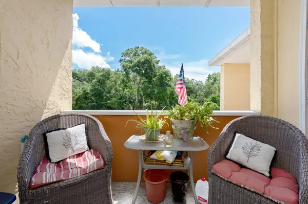 a outdoor living room with furniture and a potted plant
