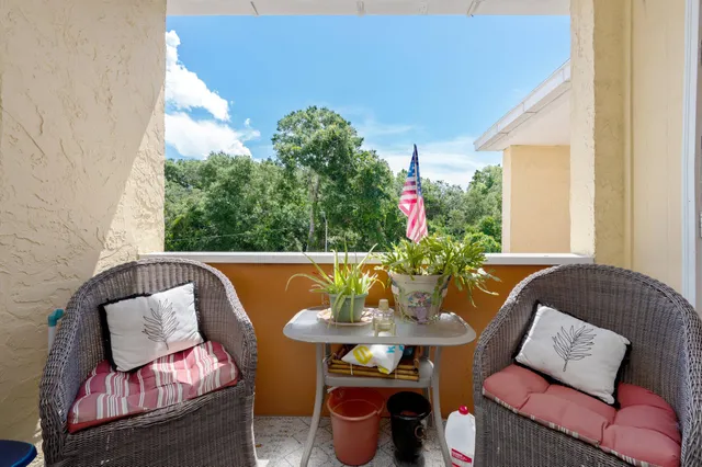 a outdoor living room with furniture and a potted plant