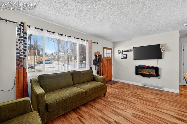 a living room with furniture and a flat screen tv