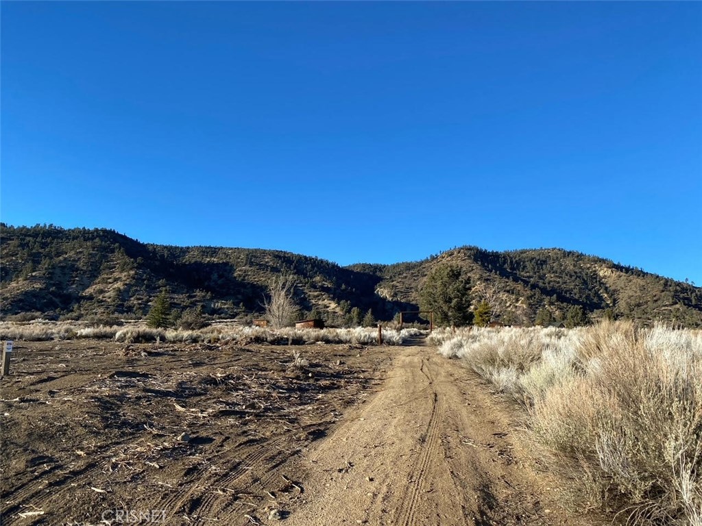 a view of a snow with a mountain in the background