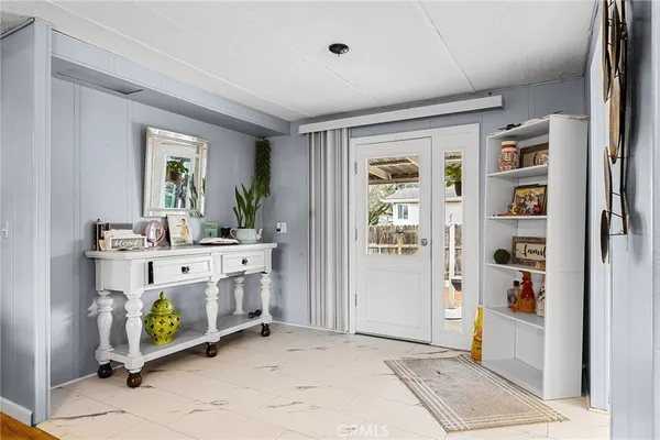 a kitchen with granite countertop a white refrigerator oven a sink and white cabinets