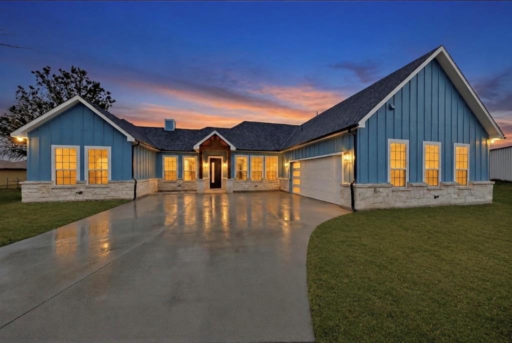 335 Cross Tie Ranch Road Trinidad, TX 75163 - Photo 1 of 30 Modern farmhouse exterior featuring blue vertical siding and stone veneer accents