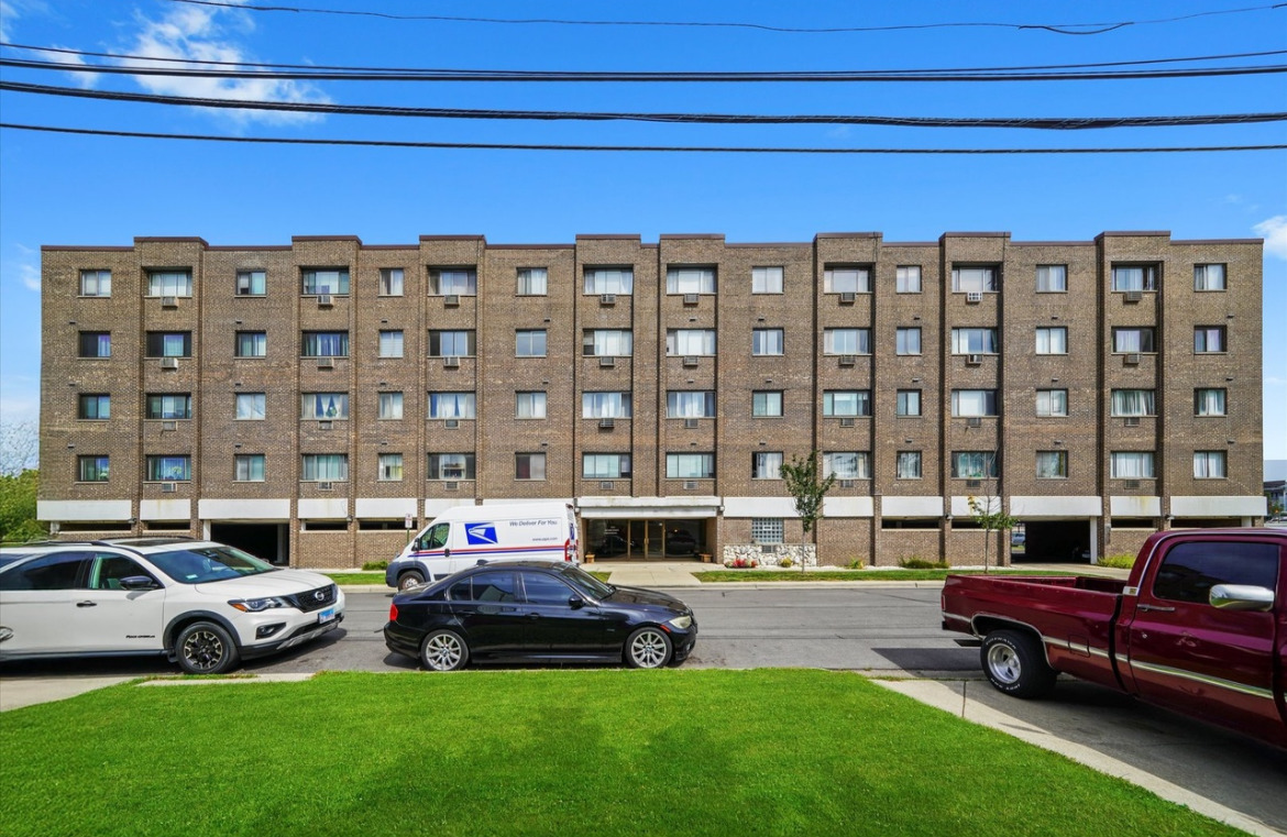 a car parked in front of a house with a yard