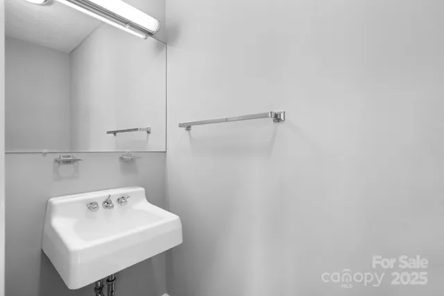 a bathroom with a sink a mirror and shower