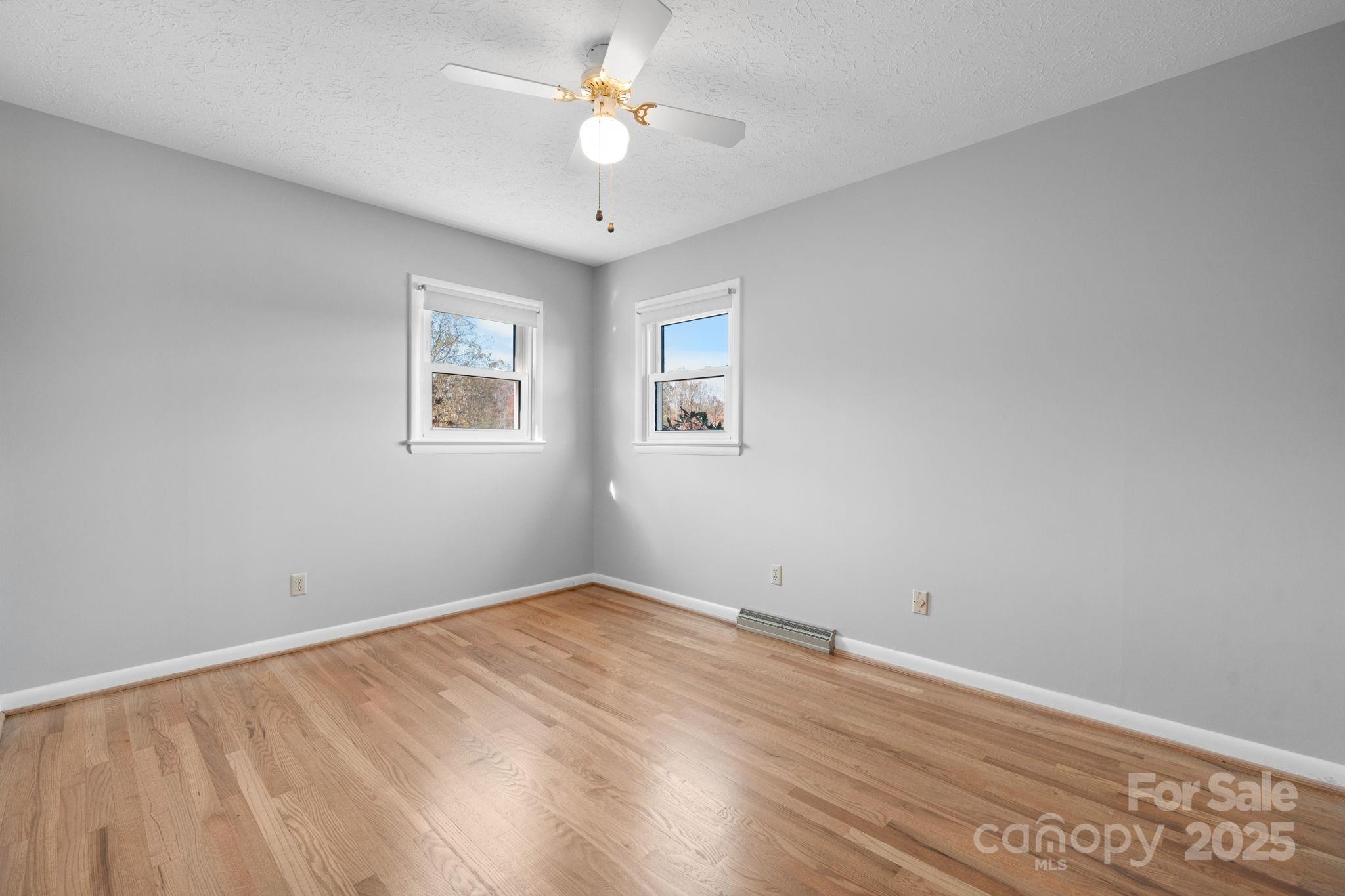 1515 Fairway Acres Road Lenoir, NC 28645 - Photo 15 of 35 wooden floor in an empty room with a window