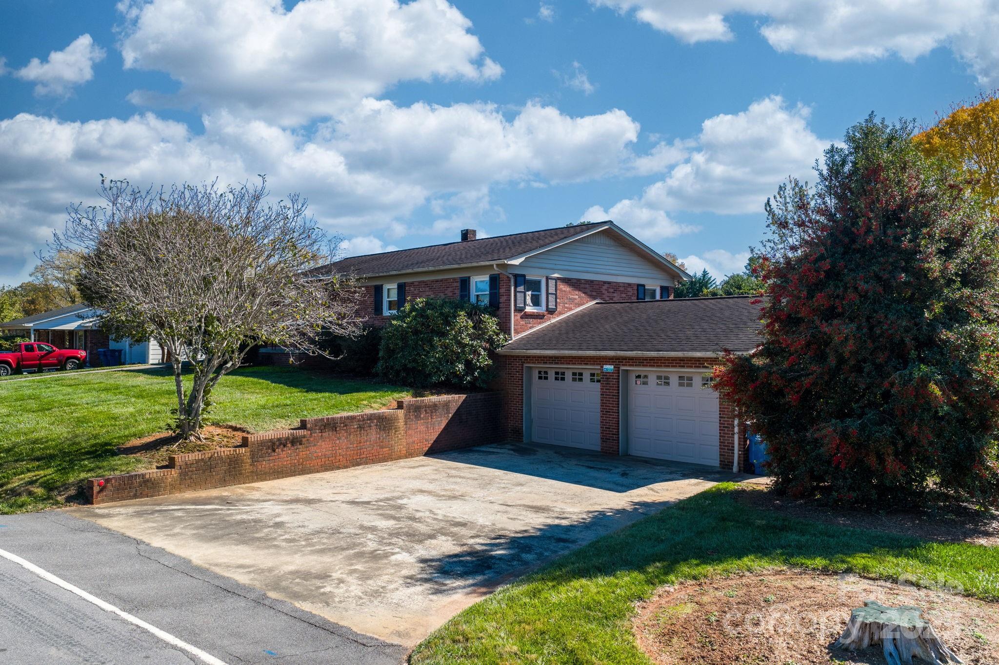 1515 Fairway Acres Road Lenoir, NC 28645 - Photo 2 of 35 a front view of a house with a garden