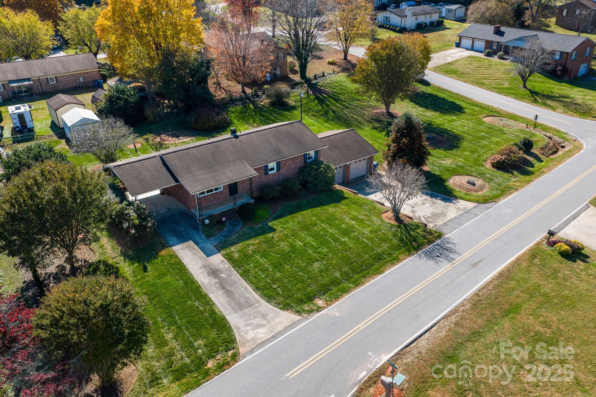 1515 Fairway Acres Road Lenoir, NC 28645 - Photo 24 of 35 an aerial view of a house with a garden and lake view