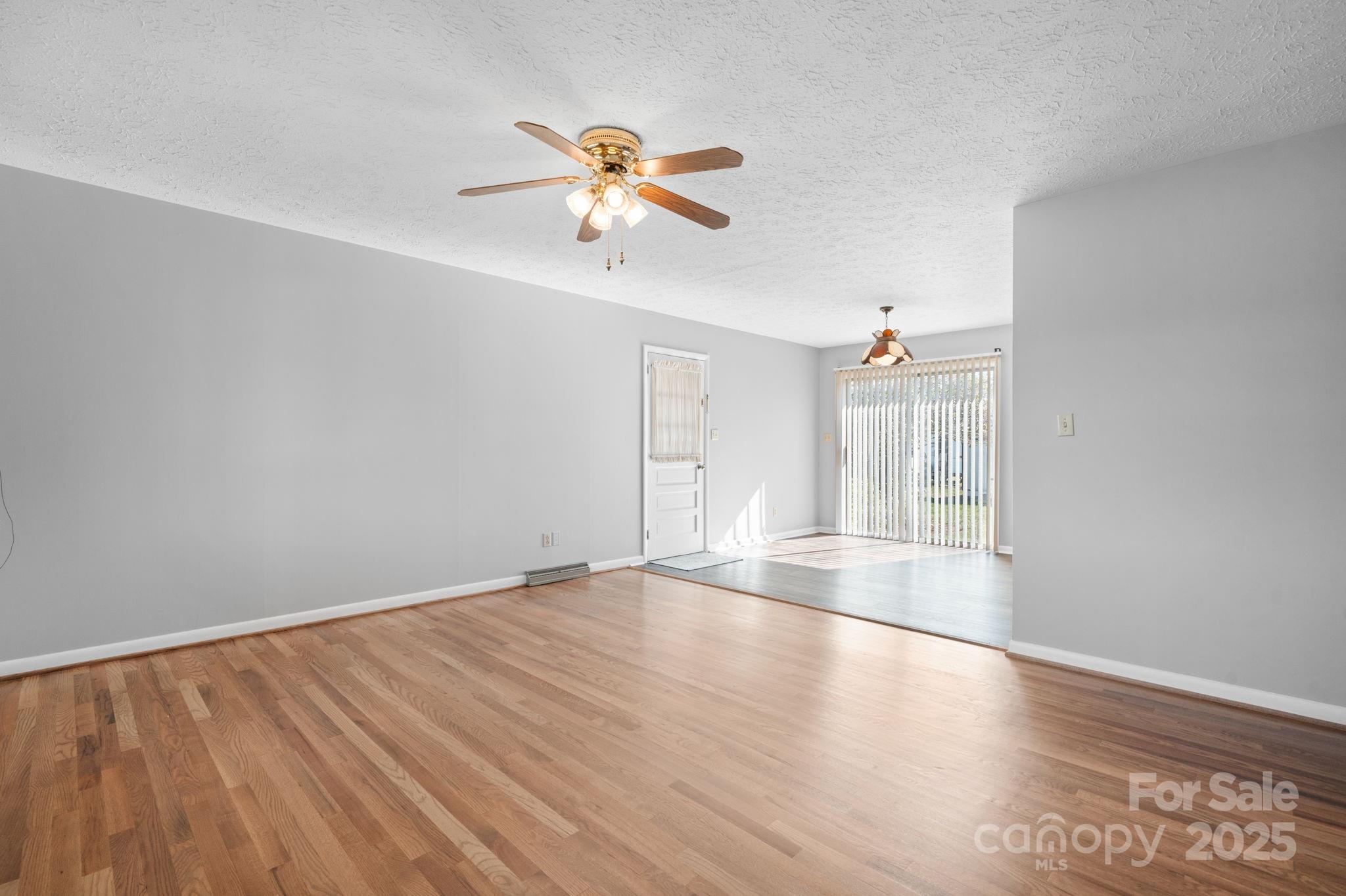 1515 Fairway Acres Road Lenoir, NC 28645 - Photo 6 of 35 wooden floor in an empty room with a window