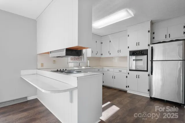 a kitchen with appliances a sink and a refrigerator