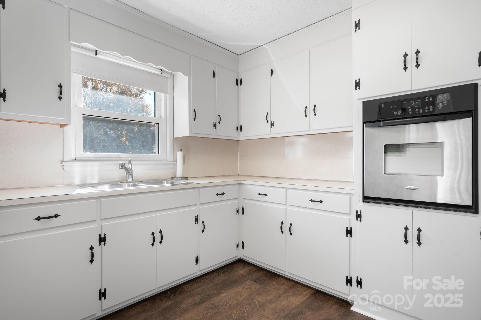 1515 Fairway Acres Road Lenoir, NC 28645 - Photo 10 of 35 a kitchen with granite countertop white cabinets and white appliances