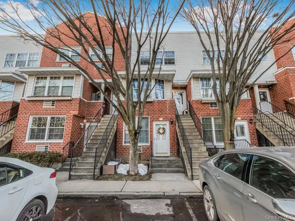 a view of a street that has couple of cars parked on the road