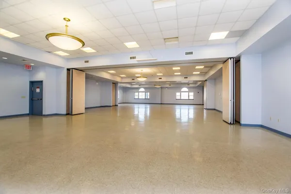 a living room with furniture a flat screen tv and a table