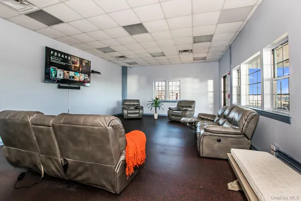 a view of swimming pool with seating area and mountain view in back