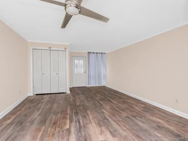 a view of an empty room and wooden floor