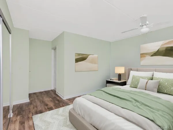 a bedroom with a bed and a painting on the wall