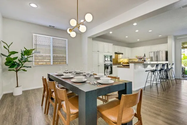 a bed sitting in a bedroom and table