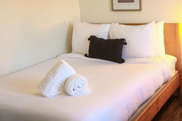 a large white bed in a white room