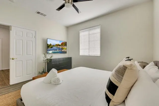 a bedroom with a bed and wooden floor