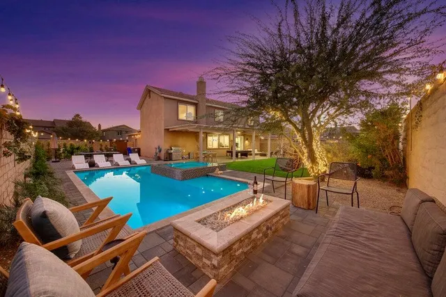 a front view of a house with a yard and potted plants