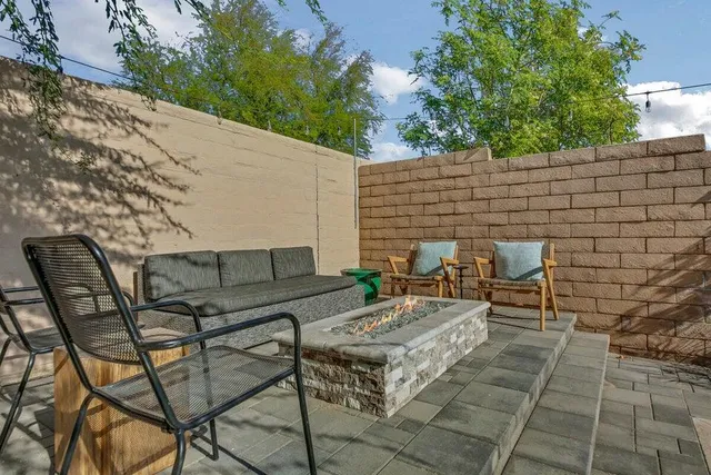 a view of a swimming pool with lake and houses in the back