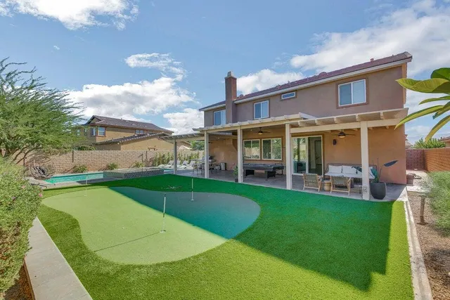 a view of lake with green yard