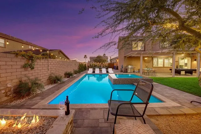 a view of a patio with a table chairs and a fire pit