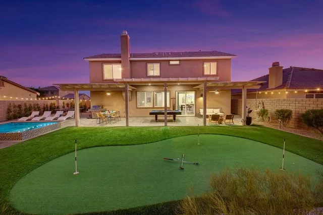 a view of a backyard with swimming pool