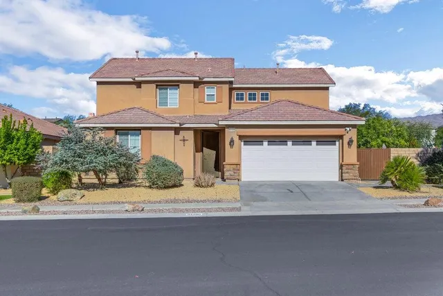 a kitchen with granite countertop white cabinets and stainless steel appliances