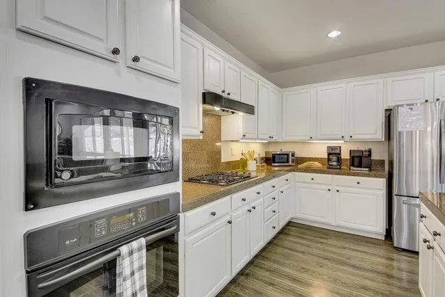 a view of a dining room with furniture and wooden floor