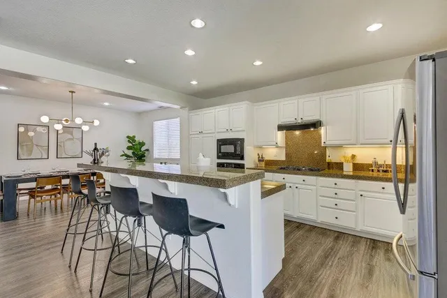 a dining room with furniture and wooden floor