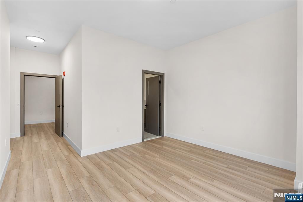 89 Mary Street, Unit 506 Paterson, NJ 07503 - Photo 12 of 15 a view of a room with wooden floor and closet