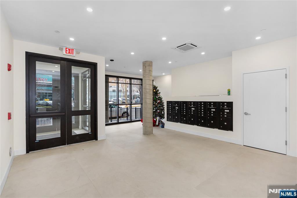 89 Mary Street, Unit 506 Paterson, NJ 07503 - Photo 15 of 15 a view of an empty room with a cabinet and mirrors