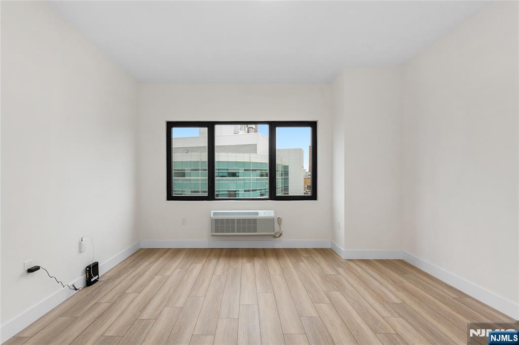 89 Mary Street, Unit 506 Paterson, NJ 07503 - Photo 6 of 15 a view of an empty room with a window