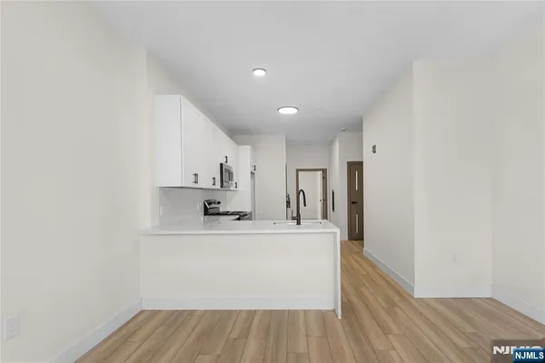 a view of room with window and hardwood floor