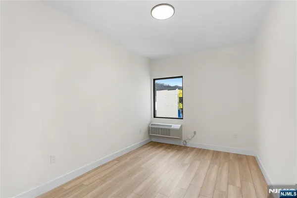 a view of a room with wooden floor