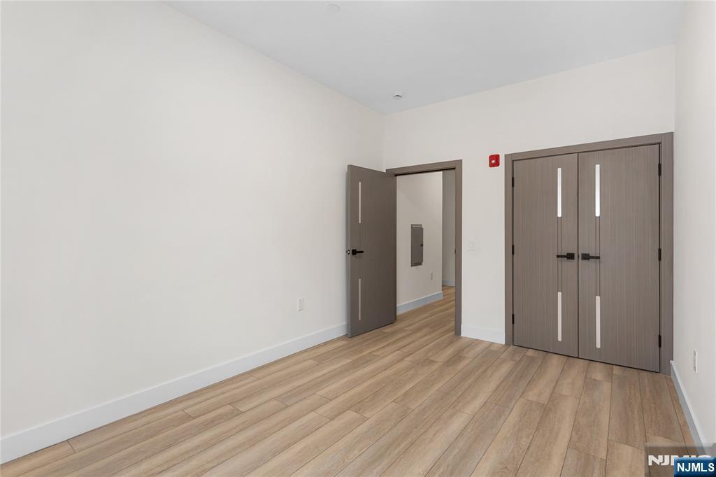 89 Mary Street, Unit 506 Paterson, NJ 07503 - Photo 10 of 15 a view of a room with wooden floor
