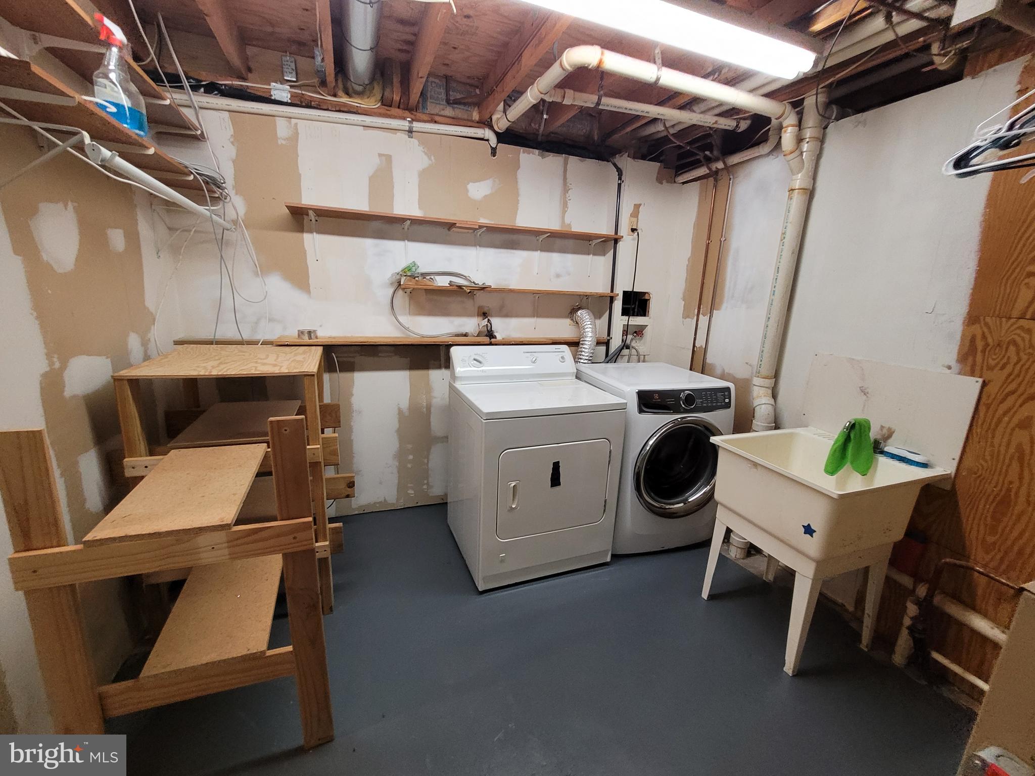 7739 Harmans Road Hanover, MD 21076 - Photo 11 of 13 Large laundry room with storage.